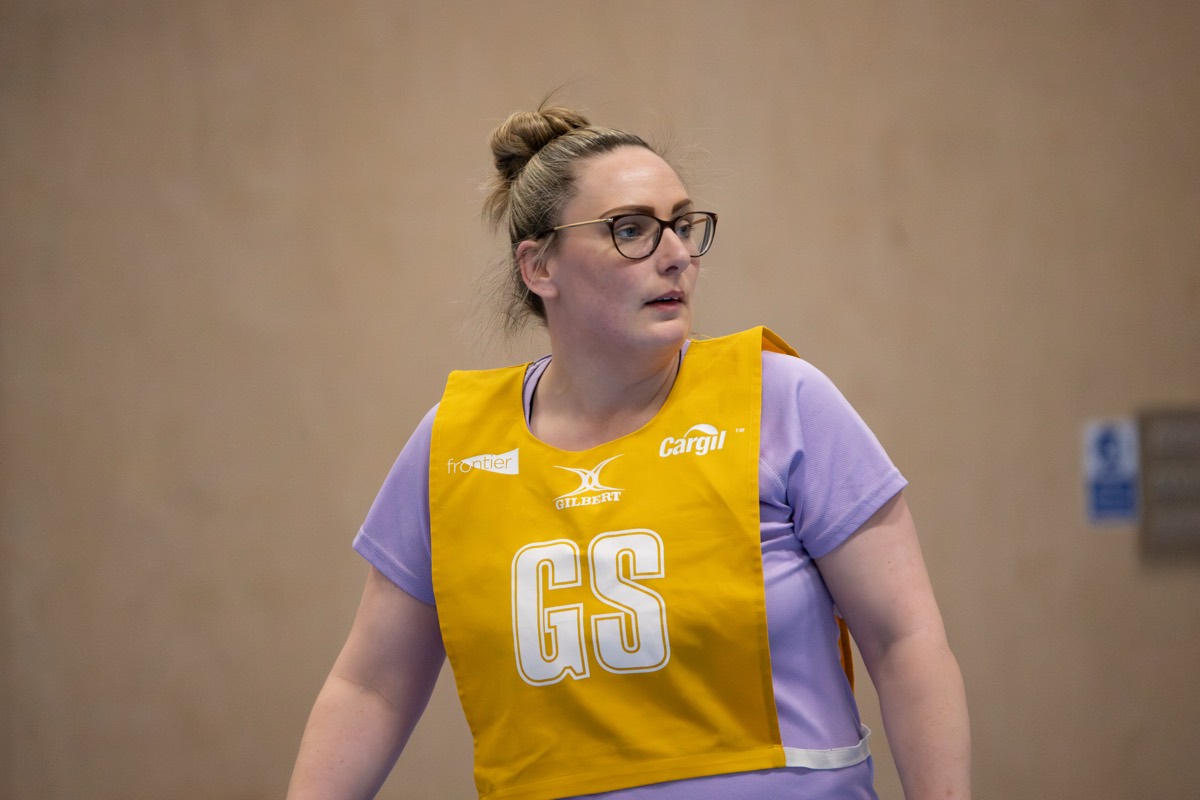 A goal shooter in her bib between plays