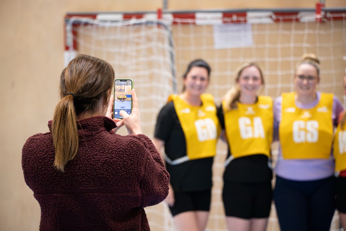 A team photo being taken on a phone