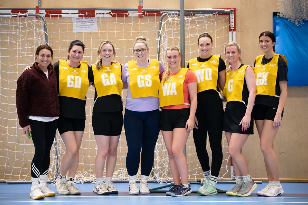 A full team lined up and smiling before the game