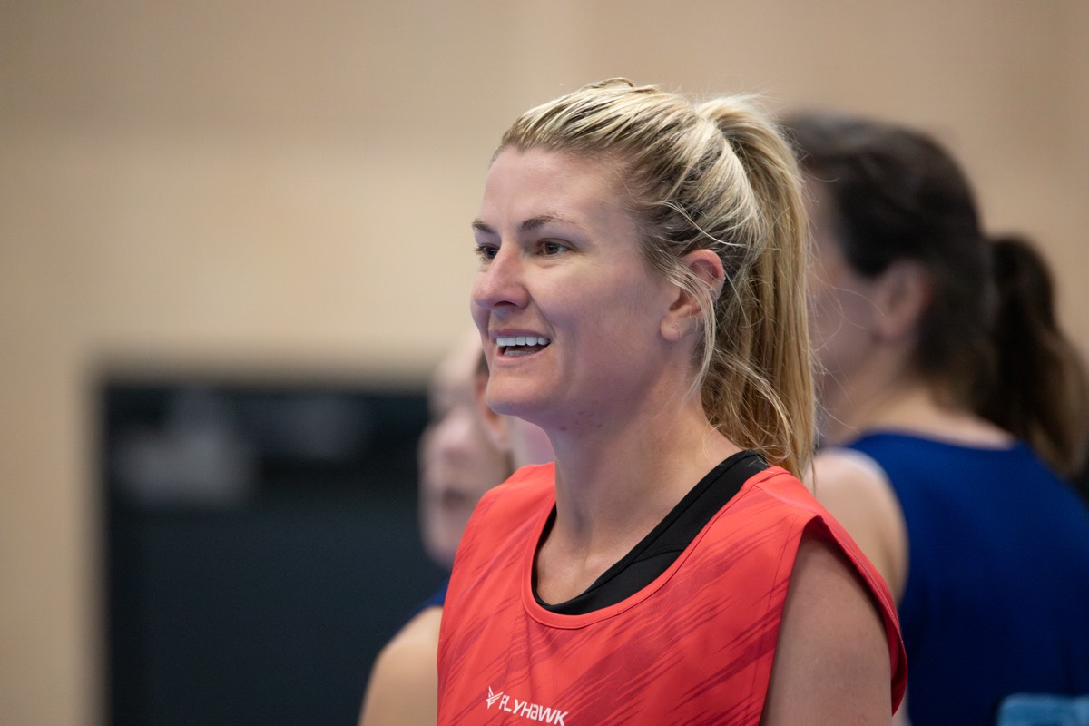 A smiling player watches the play unfold